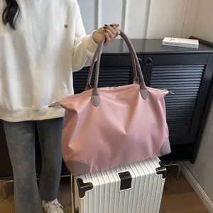 Large capacity pink travel tote bag for women, lightweight nylon weekender luggage bag.