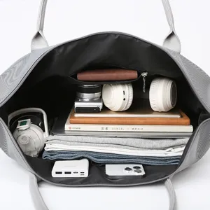 Large capacity grey travel tote bag with organized multi-pocket interior storage design.