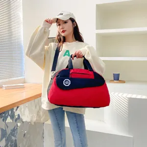Large capacity travel duffel bag, red and black foldable luggage storage bag for business trips.