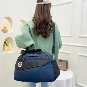 Casual travel duffel bag with shoulder strap, large capacity storage for luggage and outdoor trips.