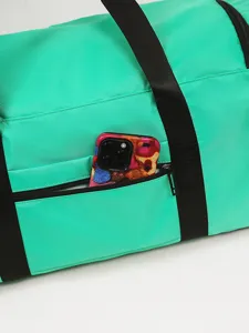 Bright green travel duffel bag with durable black straps and convenient front zipper pocket.