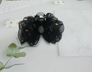 Black mesh bow hair claw clip with gilded dots and rhinestone center, elegant hair accessory.