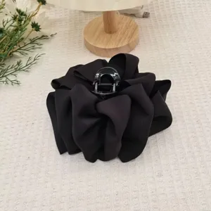 Detail shot of black satin flower hair claw clip, large cloud bubble shark clip for elegant updos