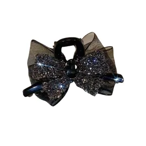 Black rhinestone bow hair claw clip, elegant sparkling side hair accessory for women.