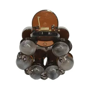 Elegant beaded hair claw clip for women, stylish brown plastic hair accessory for styling.
