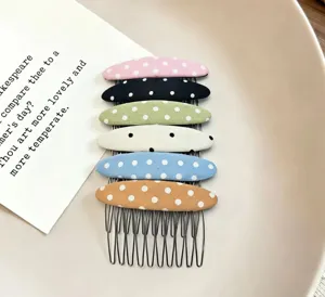 Fabric polka dot side hair comb detail shot, showcasing colorful cute hair styling accessories.