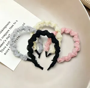 Chiffon ruffled headband detail showing soft mesh texture and delicate pleats in four colors.