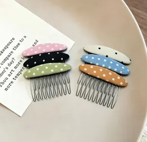 Close-up view of fabric polka dot insert combs, showing colorful hair styling accessories.
