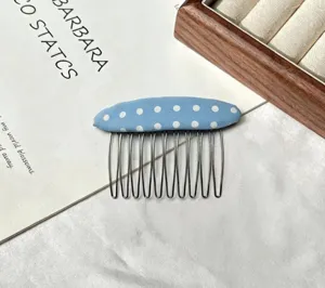Blue polka dot fabric hair comb for women stylish hair styling tool and fringe fixing accessory.