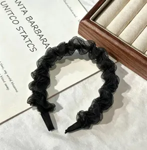 Closeup of black chiffon pleated hair hoop showing fine texture and fairy aesthetic design