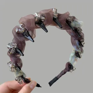 Detail shot of a luxury rhinestone organza headband with chic spikes for women hair styling.