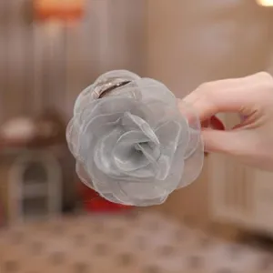 Grey organza camellia flower hair claw clip detail, elegant hair accessory for women styling.