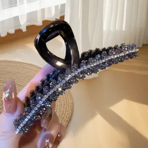 Large black rhinestone hair claw clip for women, sparkling crystal hair catch for thick hair.