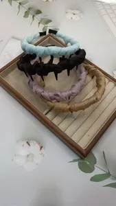 Close-up detail of multi-color fabric wrapped tooth headbands arranged nicely on tray.