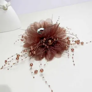 Close-up detail of the brown organza flower hair claw clip with delicate beaded pearl tendrils.