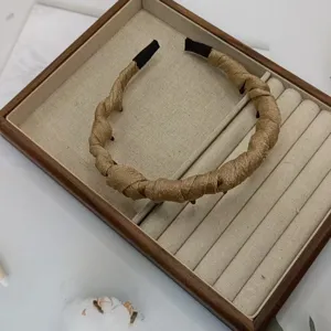 Gold braided headband with teeth for women, trendy hair accessory for daily styling.