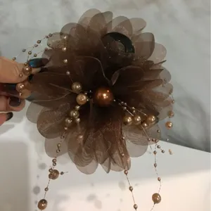 Brown organza flower hair claw clip with pearl beaded tassels for elegant hairstyles.