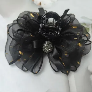 Elegant black mesh hair claw clip with gold dots, satin bow and rhinestone decoration.