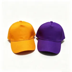 Close-up detail of plain cotton baseball caps in vibrant orange and purple colors.