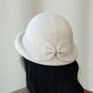 Exquisite detail of the vintage wool blend bucket hat featuring a chic bow and rhinestones.