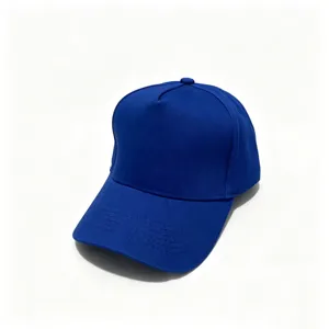 Detailed view of solid blue cotton plain baseball cap featuring hard top and curved brim.