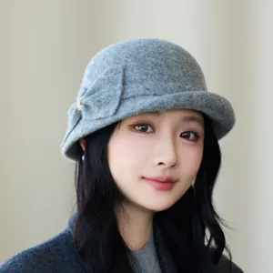 Stylish grey wool blend bucket hat for women, elegant retro bow design for autumn and winter.