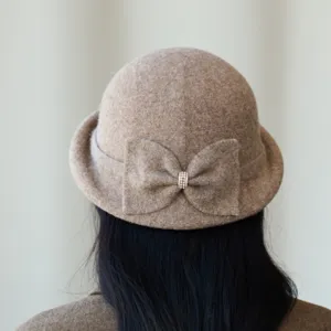 Close-up detail of women wool blend bucket hat showing back bow and rhinestone accent.