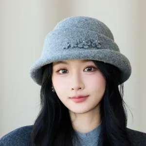 Detail shot of stylish grey wool felt bucket hat with delicate flower decoration for women.