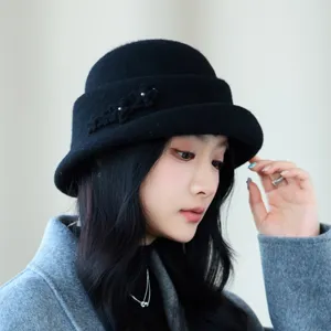 Close-up detail of the elegant black woolen bucket hat featuring delicate floral accents.