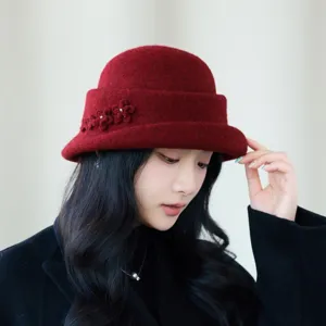 Detailed close-up of women winter wine red wool bucket hat with elegant floral side decor.