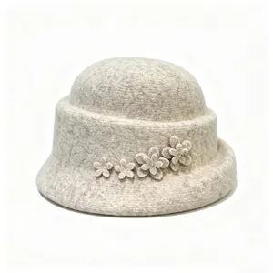 Detail view of a women wool felt cloche hat with cute floral applique, warm winter fashion.