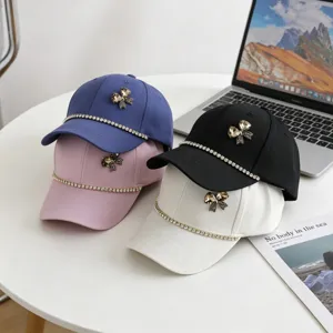 Details of kids baseball hat with rhinestone bow and chain decoration, casual summer cap.