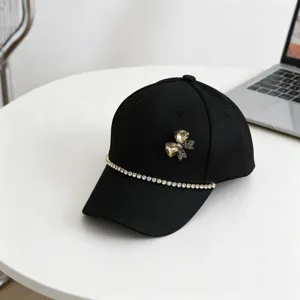 Black kids baseball cap detail showcasing sparkly rhinestone chain and elegant crystal bow.