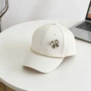 White rhinestone bow baseball cap, sparkling crystal chain detail, casual sun hat for kids.