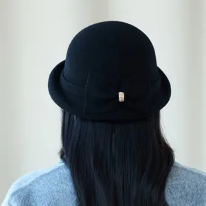 Detailed back view of a black wool blend cloche hat featuring an elegant bow and rhinestones.