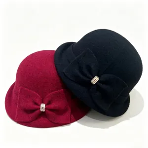 Close up detail of winter wool blend bucket hat featuring chic bow and rhinestone buckle.