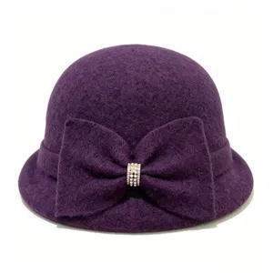 Detail shot of the purple wool blend cloche hat with an elegant bow and crystal buckle.