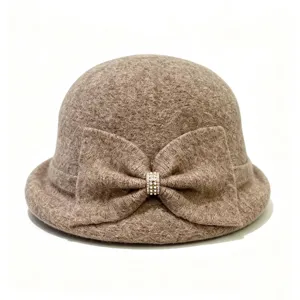 Detail view of a French retro brown wool blend bucket hat featuring a sparkling rhinestone bow.