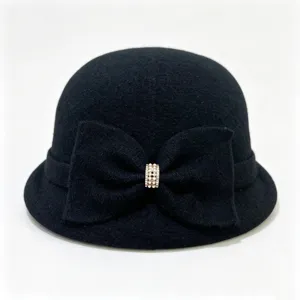 Detail view of black wool blend cloche hat with elegant bow and sparkling rhinestone buckle.