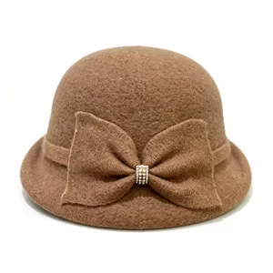Detailed view of the brown wool blend cloche hat featuring a chic bow and rhinestone accent.