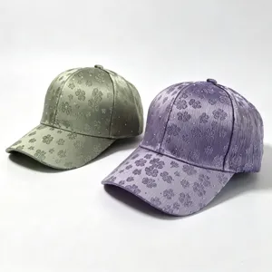 Close-up detail of stylish embroidered clover pattern baseball cap with sparkling rhinestones.