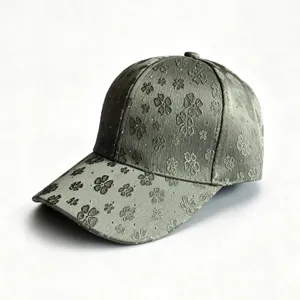 Detail view of stylish women baseball cap with floral embroidery and sparkly rhinestones.