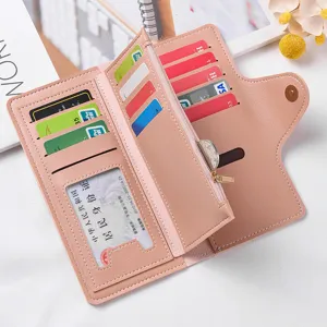 Close-up detail of women's pink long wallet, showing multiple card slots and zipper coin pocket.