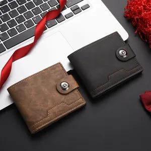 Close-up detail of trendy men's soft leather short wallets in brown and dark grey colors.