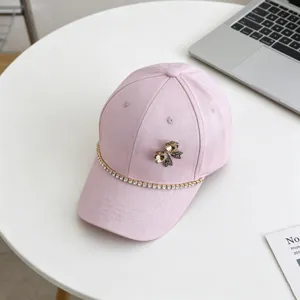 Pink children baseball cap featuring sparkling rhinestone chain on brim and elegant crystal bow details.