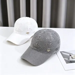 Close-up detail of knitted hollow breathable sun protection baseball hat with rhinestone heart.