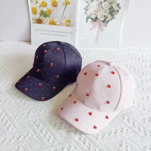 Detail shot of sweet cherry rhinestone waffle baseball caps in dark and light pink colors.