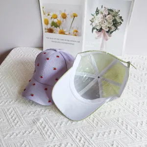Detailed view of the cute cherry embroidered baseball cap, showing waffle texture and cap structure.