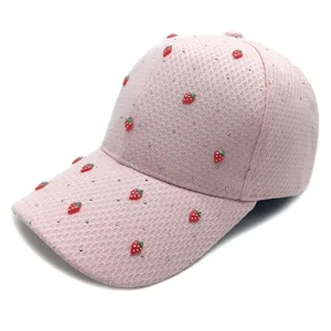 Pink mesh baseball cap detail view, featuring sparkling rhinestones and cute strawberry charms.