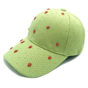 Detailed view of the cute strawberry rhinestone mesh baseball cap, close-up texture.